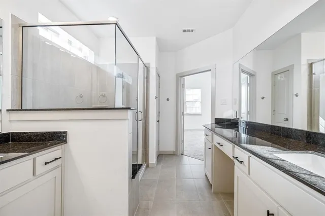 a large kitchen with granite countertop a sink and a stove