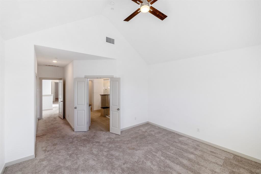 699 Vista Oak Road Lewisville, TX 75067 - Photo 31 of 35 an empty room with a hallway and wooden floor