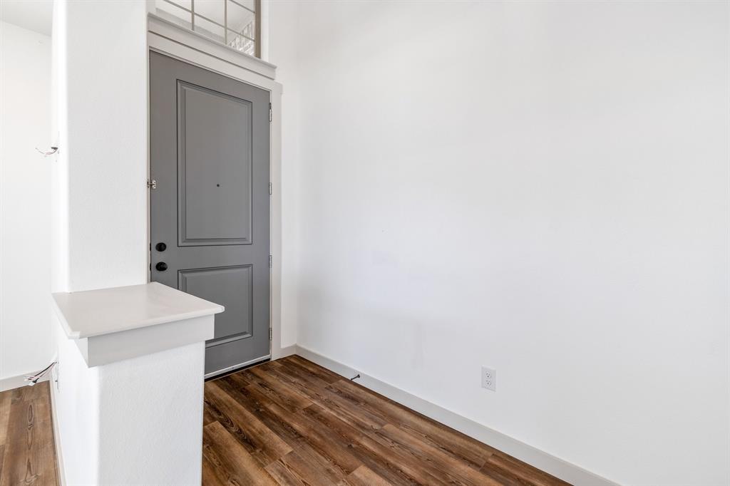 699 Vista Oak Road Lewisville, TX 75067 - Photo 6 of 35 a view of storage and utility room with wooden floor
