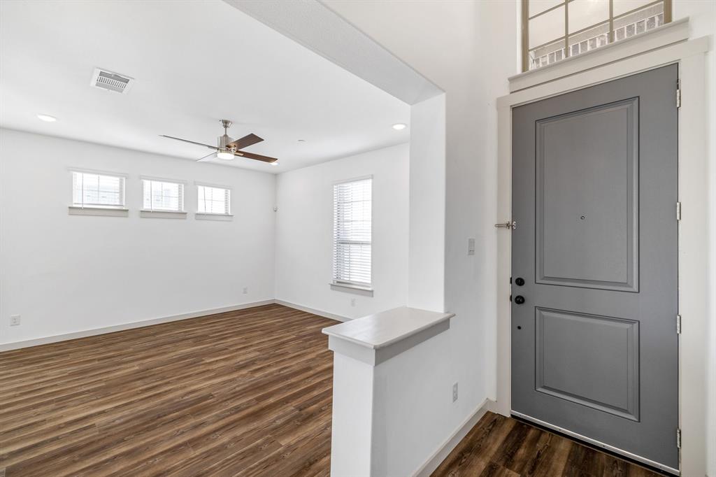 699 Vista Oak Road Lewisville, TX 75067 - Photo 7 of 35 a view of empty room with window and wooden floor