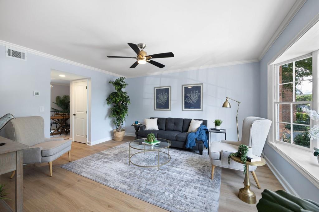 6520 Roswell Road, Unit 8 Atlanta, GA 30328 - Photo 1 of 1 a living room with furniture and a large window