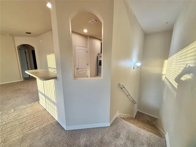 a view of a kitchen with a sink and a refrigerator