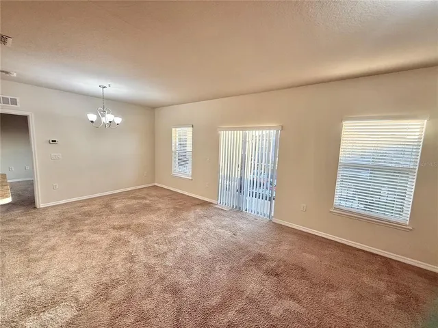 a kitchen with stainless steel appliances granite countertop a sink a stove a refrigerator a washer dryer and a refrigerator