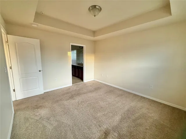 an empty room with a empty space and windows