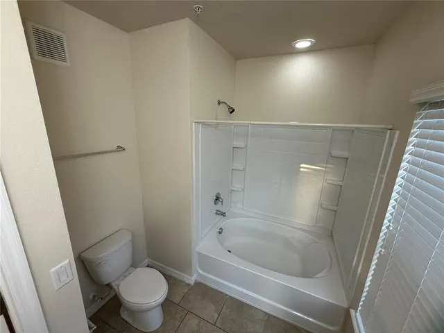a white toilet sitting next to a bathroom sink