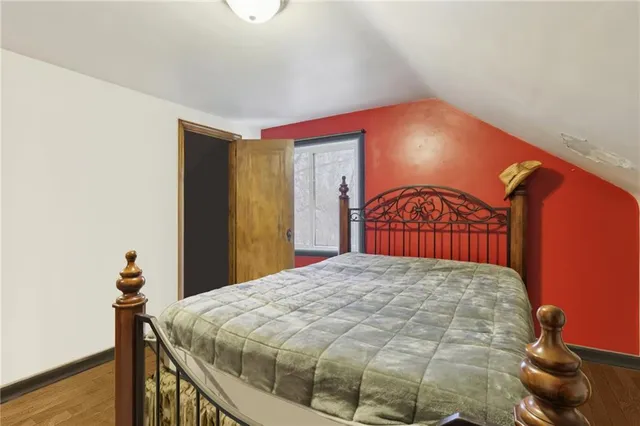 a bedroom with a bed and a dresser