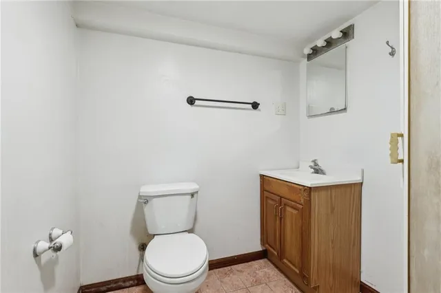 a white toilet sitting next to a bathroom sink