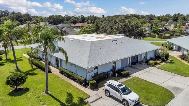 an aerial view of a house with a big yard