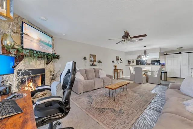 a living room with furniture a rug and white walls