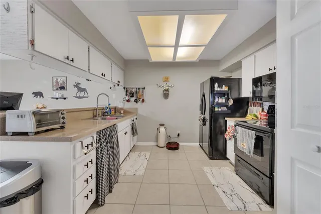 a kitchen with granite countertop a refrigerator and a sink