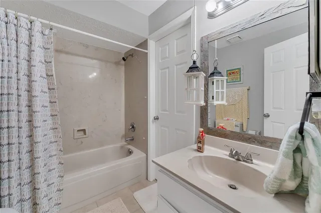 a bathroom with a tub sink and mirror