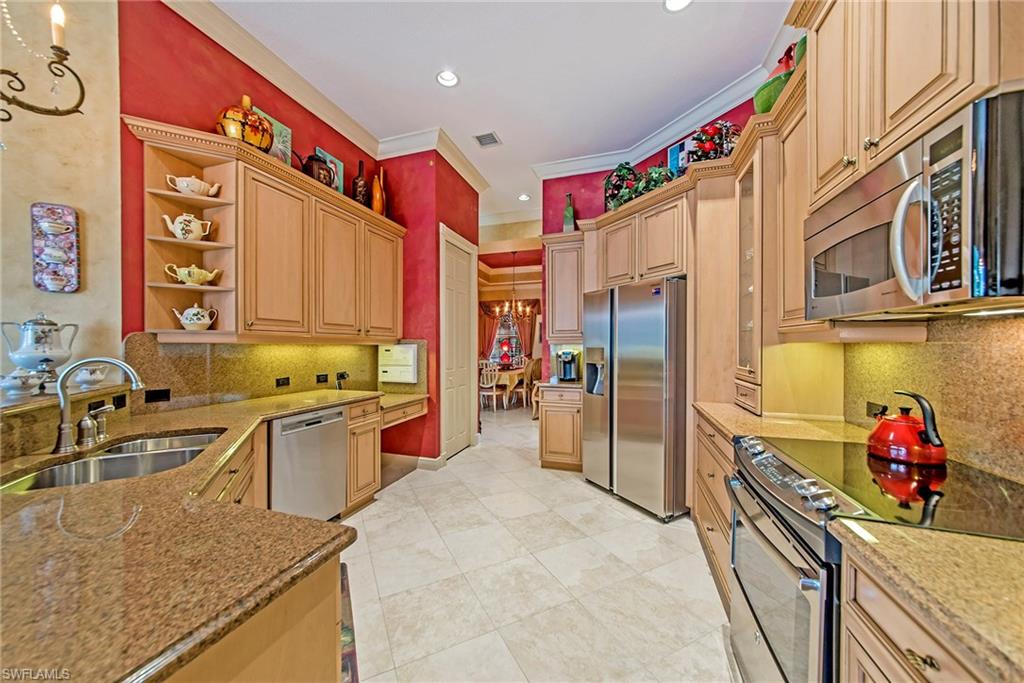 20483 Foxworth Circle Estero, FL 33928 - Photo 11 of 25 a kitchen with stainless steel appliances granite countertop a sink and dishwasher a refrigerator a oven with wooden cabinets