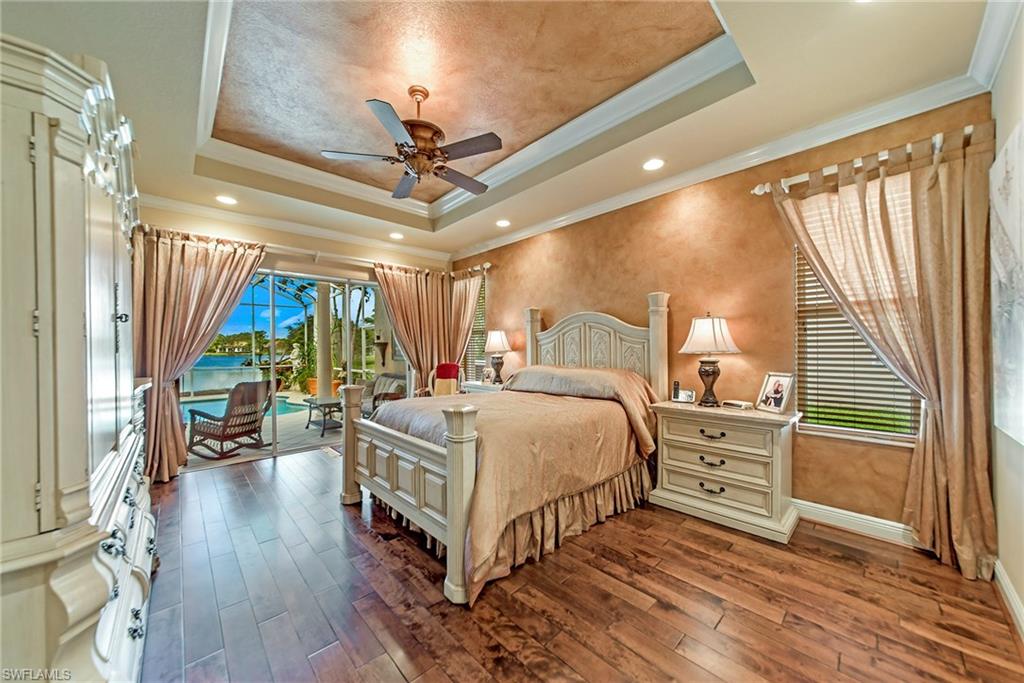 20483 Foxworth Circle Estero, FL 33928 - Photo 17 of 25 a bedroom with a bed and a chandelier