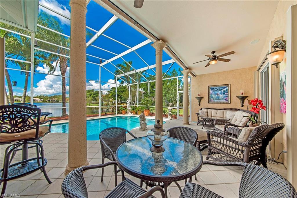 20483 Foxworth Circle Estero, FL 33928 - Photo 20 of 25 a living room with furniture and a floor to ceiling window