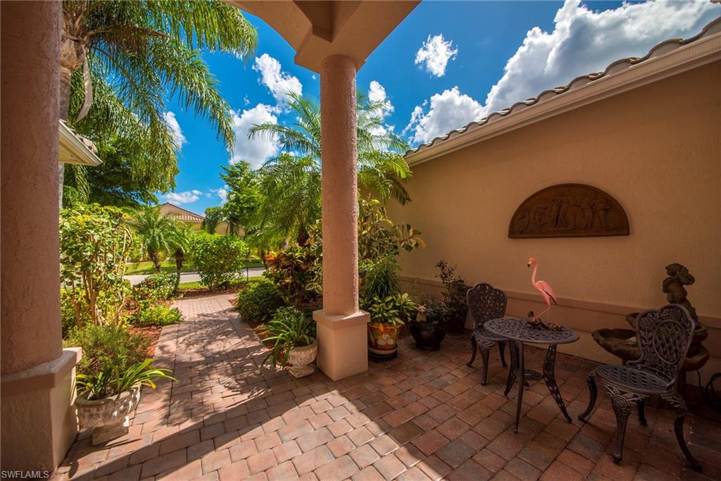 20483 Foxworth Circle Estero, FL 33928 - Photo 3 of 25 a backyard of a house with table and chairs