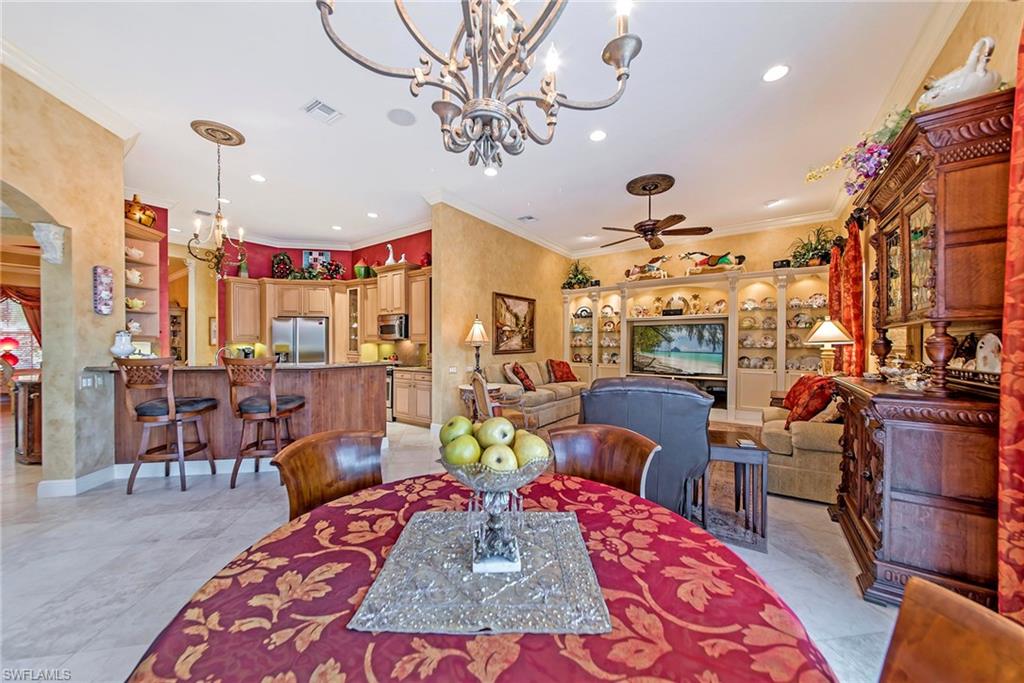 20483 Foxworth Circle Estero, FL 33928 - Photo 8 of 25 a living room with lots of furniture and a chandelier