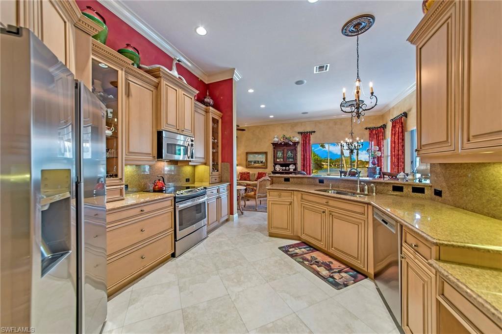 20483 Foxworth Circle Estero, FL 33928 - Photo 10 of 25 a kitchen with stainless steel appliances granite countertop a sink and cabinets