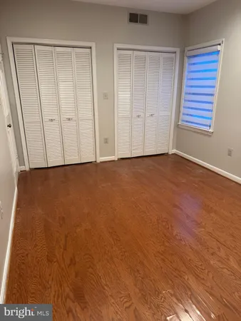 an empty room with furniture and a window