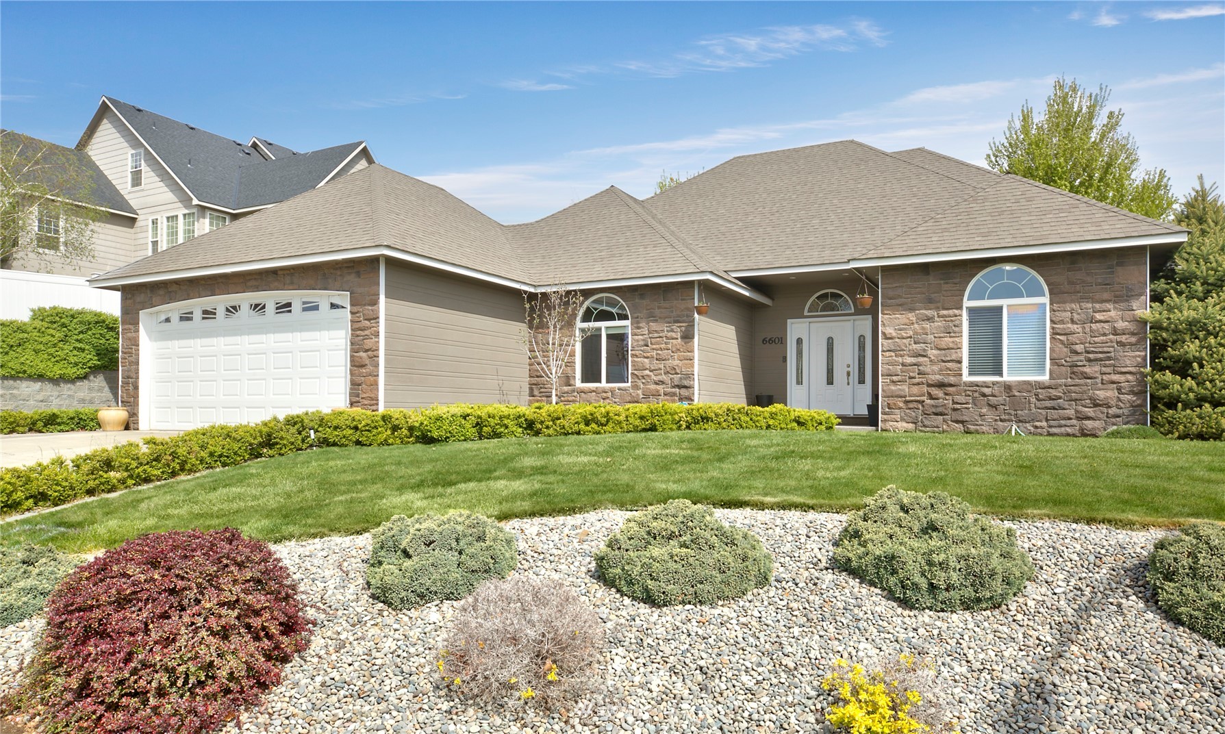 6601 Cherry Ridge Court Yakima, WA 98908 - Photo 1 of 21 a front view of a house with a yard
