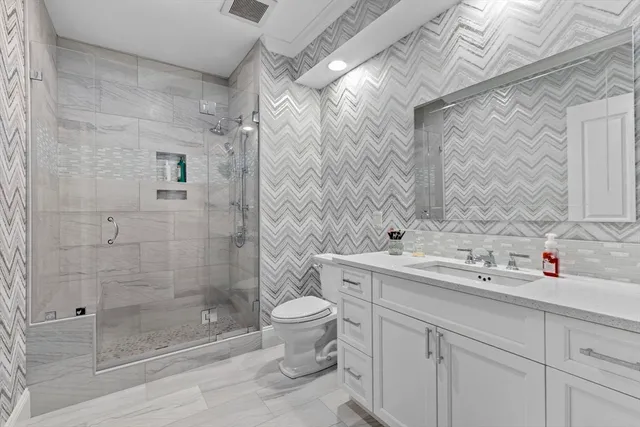 a bathroom with a sink toilet and shower