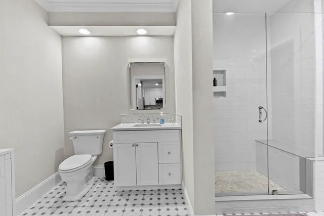 a bathroom with a toilet a sink and a mirror