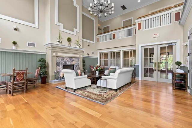 a living room with furniture a fireplace and a chandelier