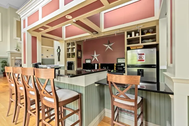 a patio with a table and chairs and potted plants