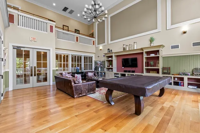 a living room with furniture a table and kitchen view