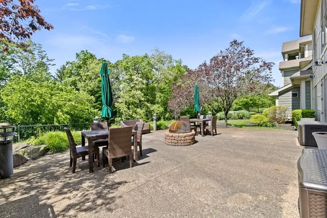 a view of a patio with table and chairs and potted plants