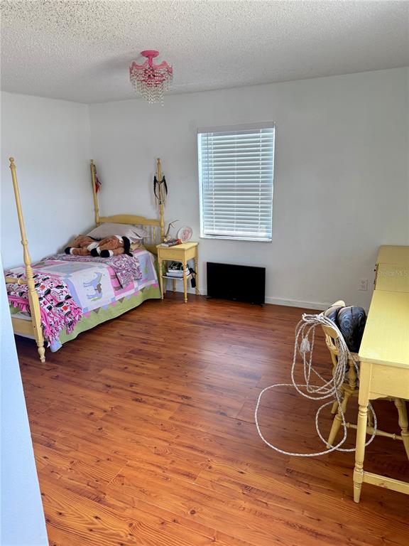 439 Corbett Road Lithia, FL 33547 - Photo 14 of 27 a bedroom with a bed and wooden floor