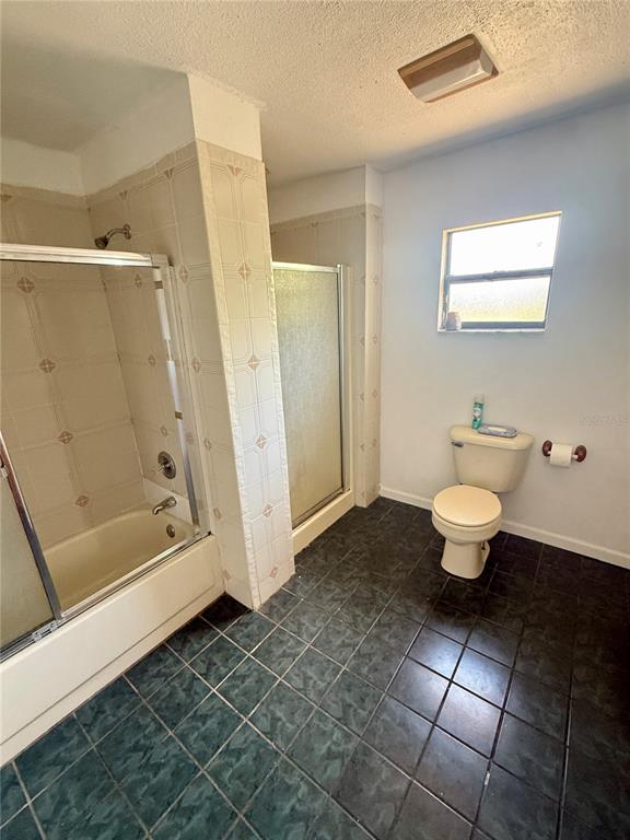 439 Corbett Road Lithia, FL 33547 - Photo 16 of 27 a bathroom with a toilet and a shower