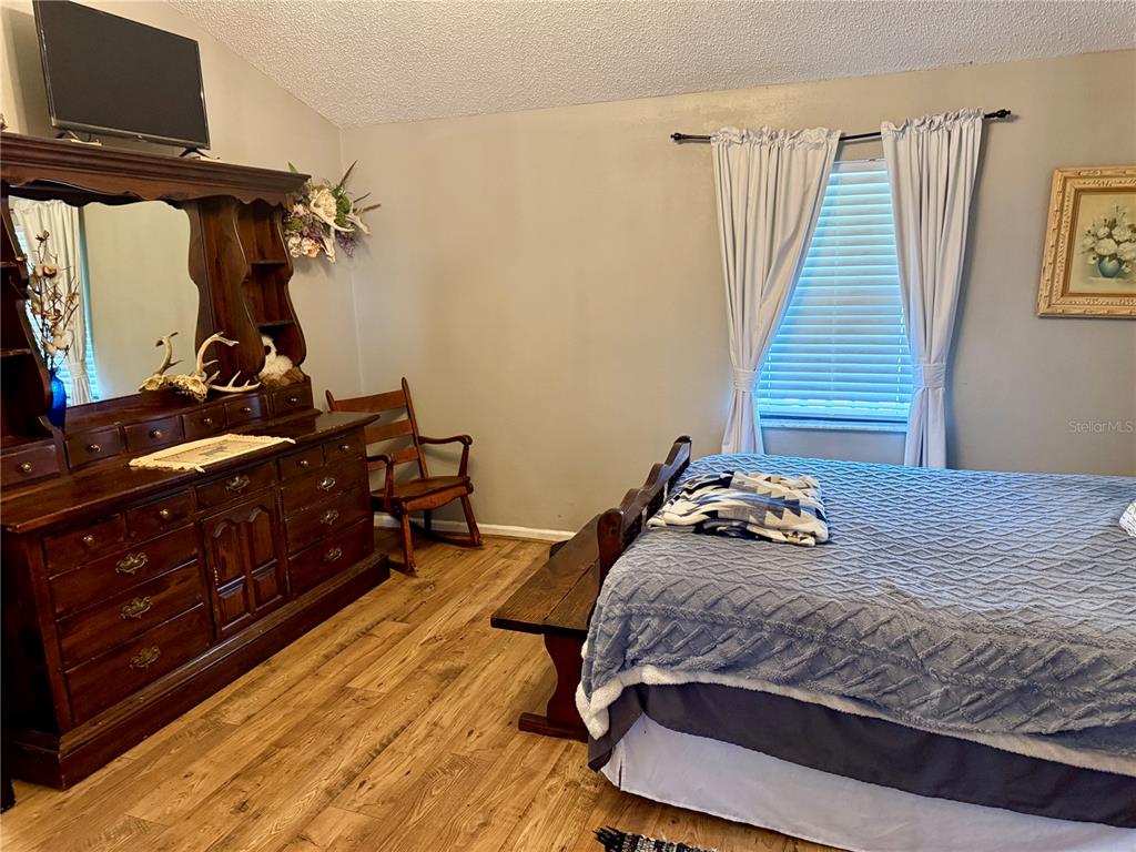439 Corbett Road Lithia, FL 33547 - Photo 17 of 27 a bedroom with a bed and wooden floor