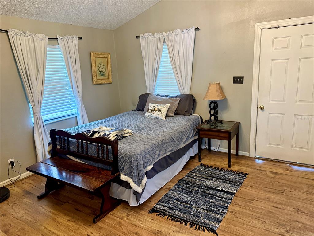 439 Corbett Road Lithia, FL 33547 - Photo 18 of 27 a bedroom with a bed and wooden floor