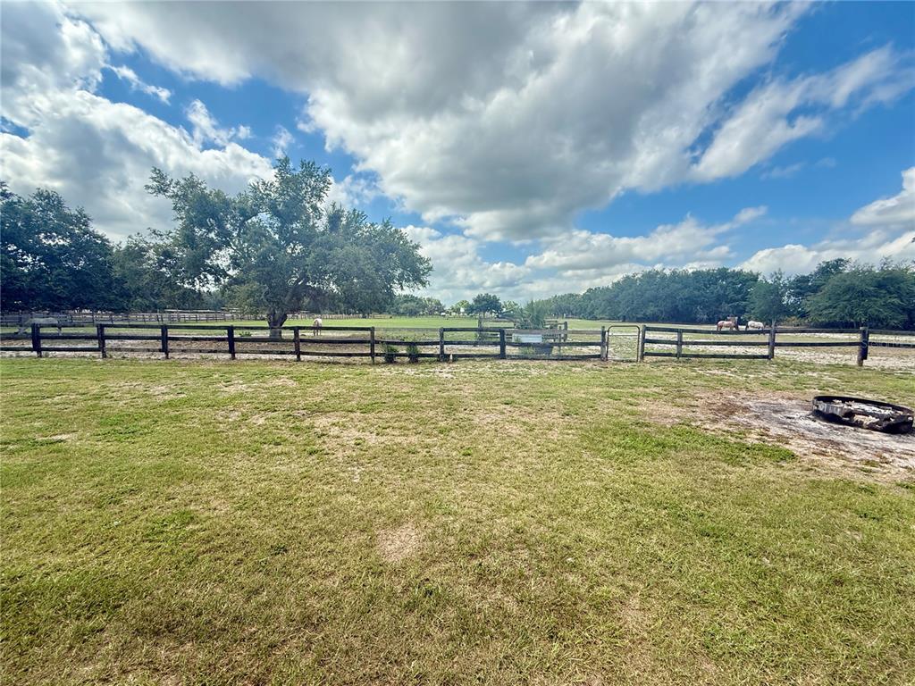 439 Corbett Road Lithia, FL 33547 - Photo 2 of 27 a view of a swimming pool with an outdoor seating and a yard