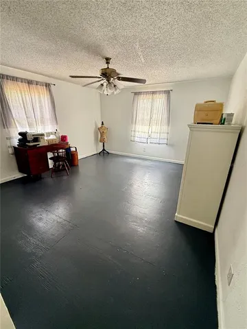 a view of a livingroom with furniture and a ceiling fan