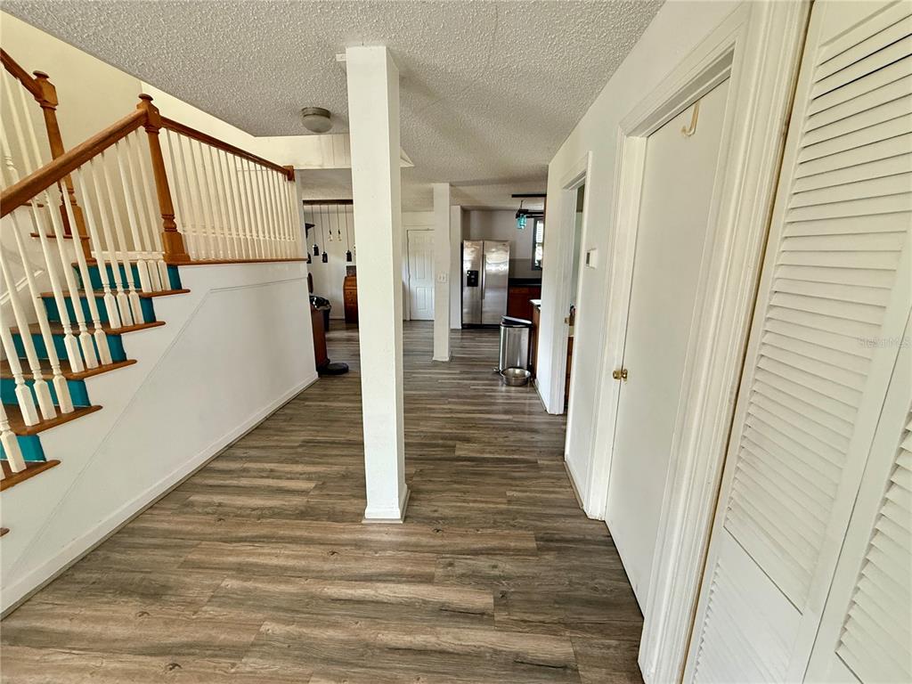439 Corbett Road Lithia, FL 33547 - Photo 5 of 27 a view of a hallway with wooden floor and staircase