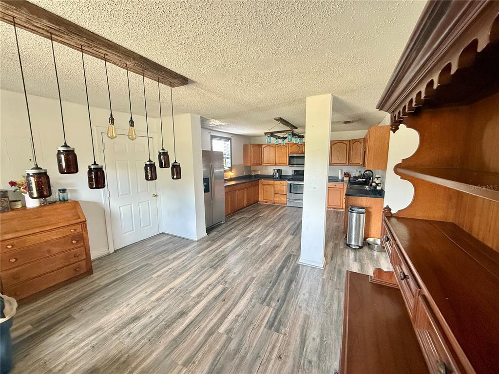 439 Corbett Road Lithia, FL 33547 - Photo 8 of 27 a view of a living room with furniture and wooden floor