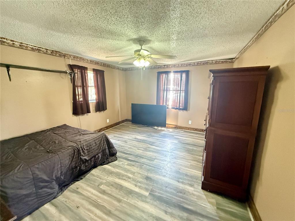 439 Corbett Road Lithia, FL 33547 - Photo 10 of 27 a bedroom with a bed dresser and a window