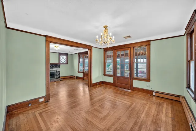 wooden floor in an empty room with a window
