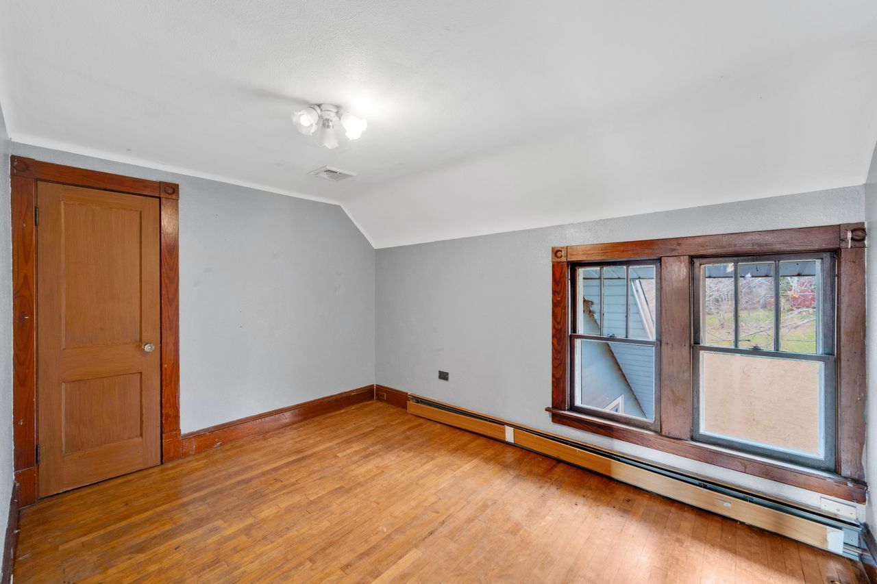 115 West Stafford Road Stafford, CT 06076 - Photo 28 of 39 an empty room with wooden floor and windows