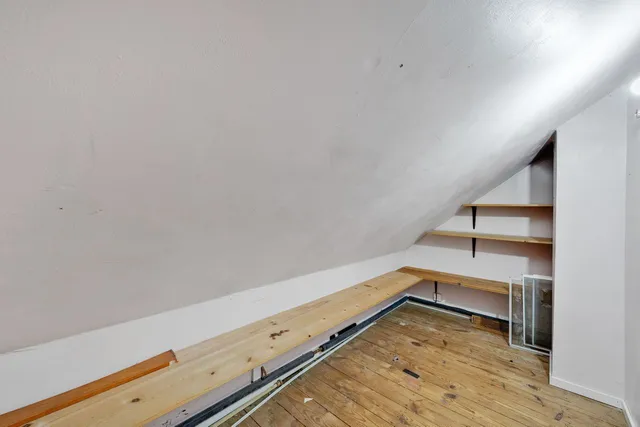 a view of a room with wooden floor