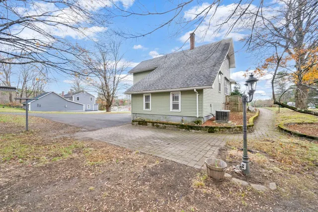 a view of a house with a yard covered in snow