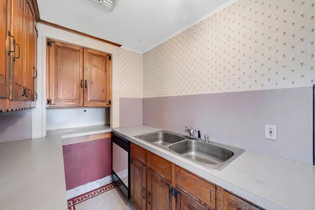 a kitchen with a sink and cabinets