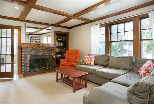 128 Lovell Road Watertown, MA 02472 - Photo 2 of 6 a living room with furniture and a fireplace