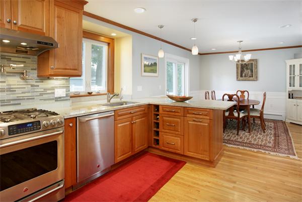 128 Lovell Road Watertown, MA 02472 - Photo 4 of 6 a kitchen with stainless steel appliances granite countertop a stove a sink and a microwave