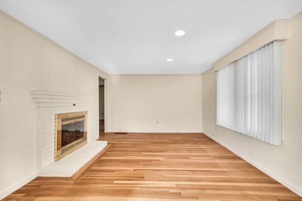 8 Rice Street Hopkinton, MA 01748 - Photo 4 of 16 a view of an empty room with a fireplace and a window