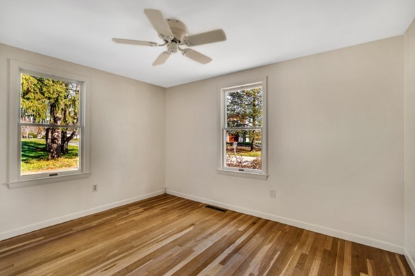 8 Rice Street Hopkinton, MA 01748 - Photo 8 of 16 a view of an empty room with a window and wooden floor