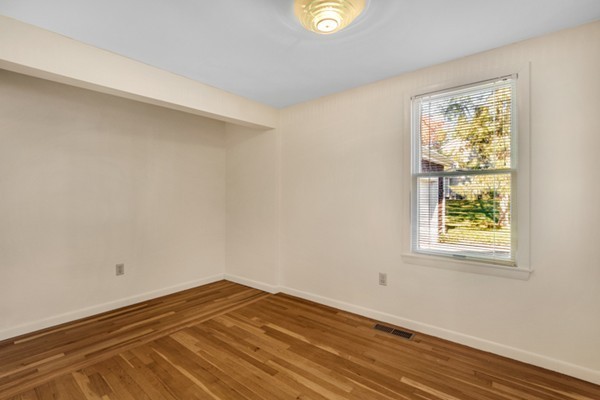 8 Rice Street Hopkinton, MA 01748 - Photo 9 of 16 a view of an empty room with wooden floor and a window