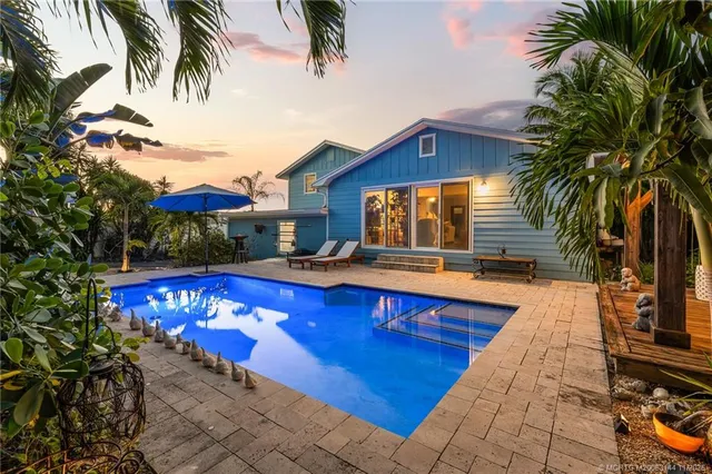 a view of a livingroom with furniture and a hallway