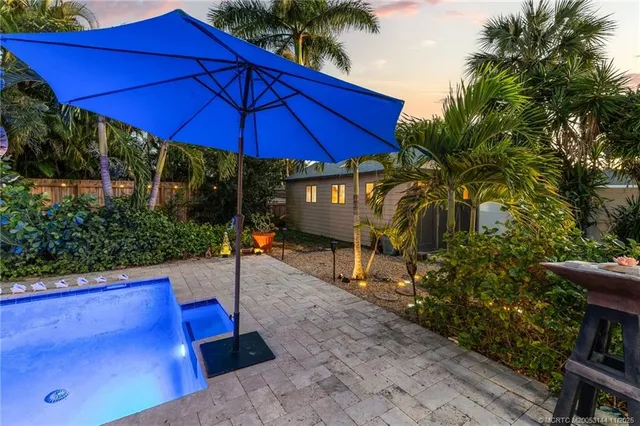 a kitchen with stainless steel appliances kitchen island granite countertop a refrigerator and a stove top oven